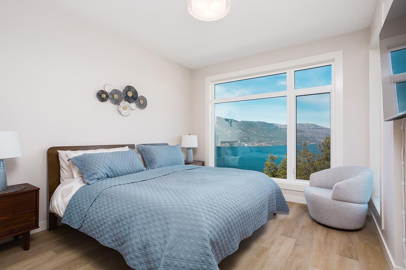 Primary bedroom with king bed and lake view