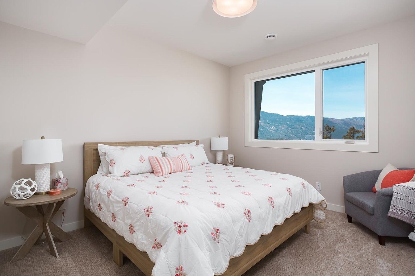 Lower-level bedroom with mountain and lake view